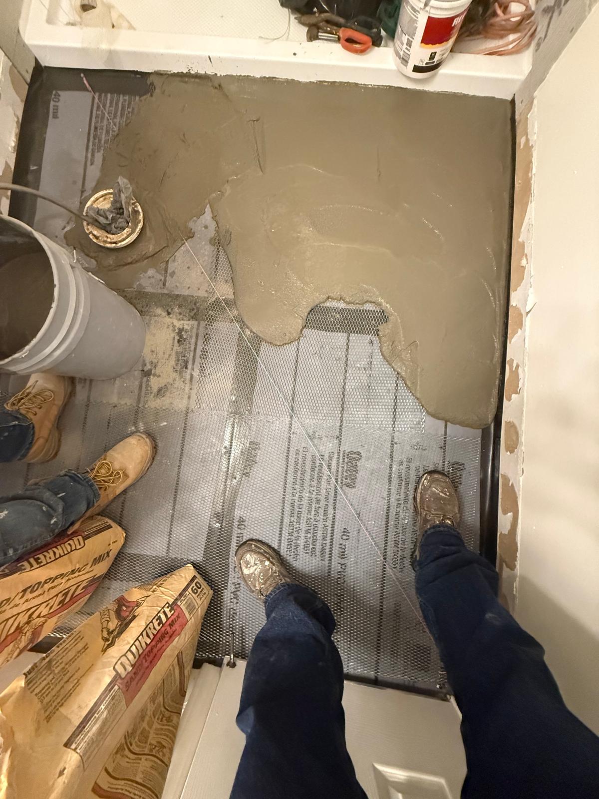 Sloped mortar bed being floated over the pan liner